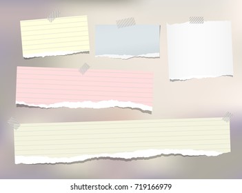 Note, notebook, copybook paper strips stuck with sticky tape on colorful background.