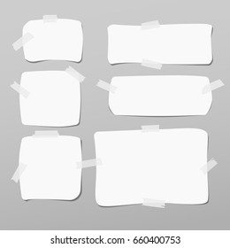 Note, notebook, copybook paper, stuck with white sticky tape on grey background.