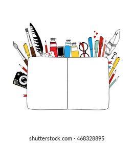 Notebook and art materials on white background.