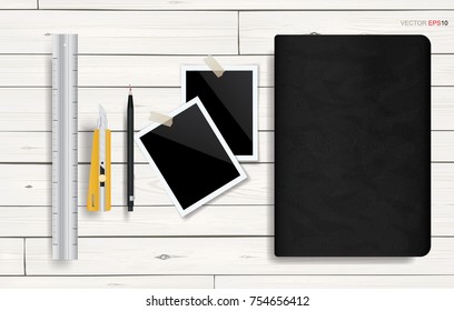 Notebook and blank photo frame with stationery set on white wooden texture background. Vector illustration.