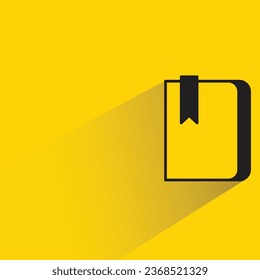 notebook and bookmark with shadow on yellow background