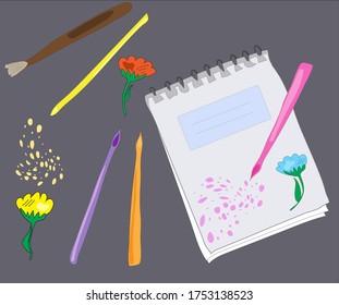 A notebook, colored pencils and brush on a dark background.