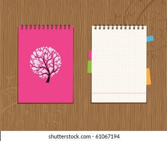 Notebook cover and page design on wooden background