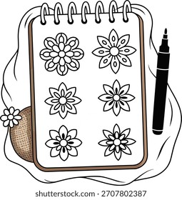 Notebook mit Blumen-Designs und schwarzem Marker-Notizblock
