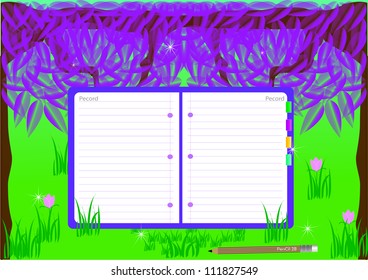 Notebook on the background of grass and trees.