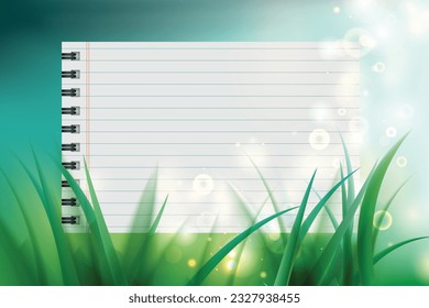 Notebook paper on green grass background with bokeh