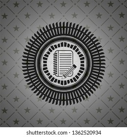 notebook with pencil icon inside black emblem