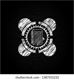 notebook with pencil icon inside chalkboard emblem on black board