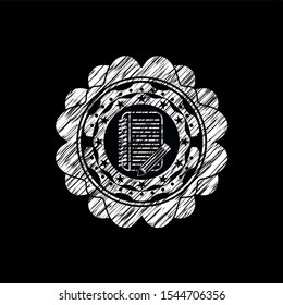 notebook with pencil icon inside chalkboard emblem on black board