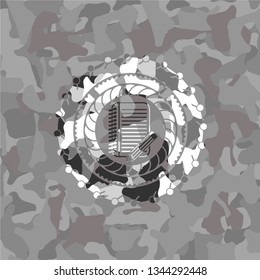 notebook with pencil icon inside grey camouflage texture
