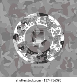 notebook with pencil icon inside grey camo emblem