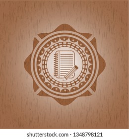 notebook with pencil icon inside realistic wooden emblem