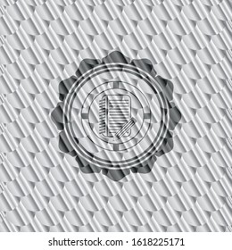 notebook with pencil icon inside silver shiny emblem. Scales pattern. Vector Illustration. Detailed.