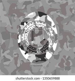 notebook with pencil icon on grey camouflage texture