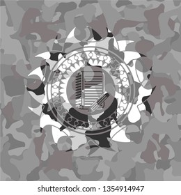 notebook with pencil icon on grey camo texture