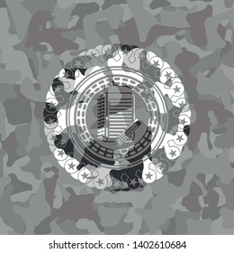 notebook with pencil icon on grey camouflage pattern
