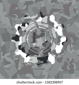 notebook with pencil icon on grey camouflage texture