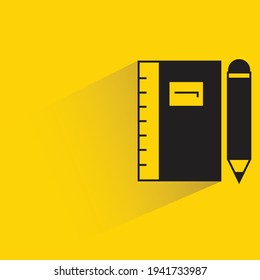 notebook and pencil with shadow on yellow background