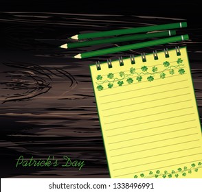 Notebook with template hand-drawn Green festive bunting with clover and pencil. Irish holiday - Happy St. Patrick's Day with a garland of three-leaf. Vector on wooden background