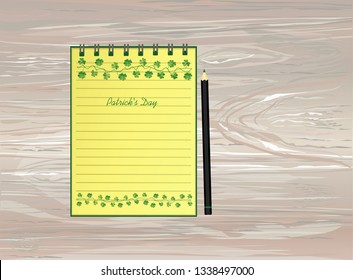 Notebook with template hand-drawn Green festive bunting with clover and pencil. Irish holiday - Happy St. Patrick's Day with a garland of three-leaf. Vector on wooden background