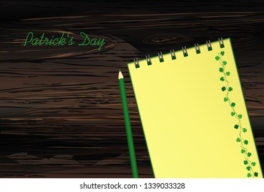 Notebook with template hand-drawn Green festive bunting with clover and pencil. Irish holiday - Happy St. Patrick's Day with a garland of three-leaf. Vector on wooden background