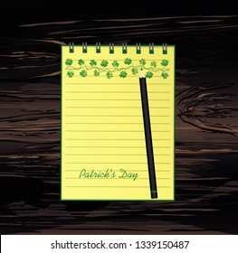 Notebook with template hand-drawn Green festive bunting with clover and pencil. Irish holiday - Happy St. Patrick's Day with a garland of three-leaf. Vector on wooden background