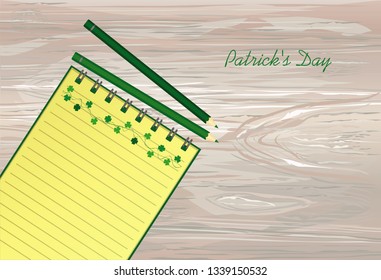 Notebook with template hand-drawn Green festive bunting with clover and pencil. Irish holiday - Happy St. Patrick's Day with a garland of three-leaf. Vector on wooden background