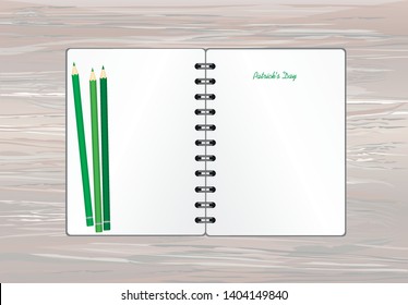 Notebook with template hand-drawn Green festive bunting with clover and pencil. Irish holiday - Happy St. Patrick's Day with a garland of three-leaf. Greeting card on holiday. Vector on wooden back