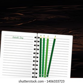 Notebook with template hand-drawn Green festive bunting with clover and pencil. Irish holiday - Happy St. Patrick's Day with a garland of three-leaf. Greeting card on holiday. Vector on wooden back