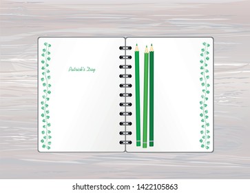 Notebook with template hand-drawn Green festive bunting with clover and pencil. Irish holiday - Happy St. Patrick's Day with a garland of three-leaf. Greeting card on holiday. Vector on wooden back