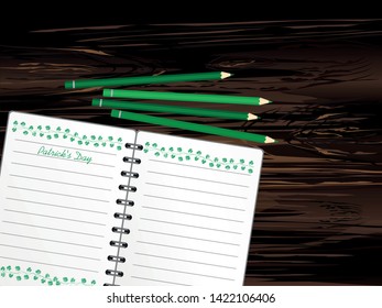 Notebook with template hand-drawn Green festive bunting with clover and pencil. Irish holiday - Happy St. Patrick's Day with a garland of three-leaf. Greeting card on holiday. Vector on wooden back
