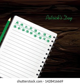 Notebook with template hand-drawn Green festive bunting with clover and pencil. Irish holiday - Happy St. Patrick's Day with a garland of three-leaf. Greeting card on holiday. Vector on wooden back