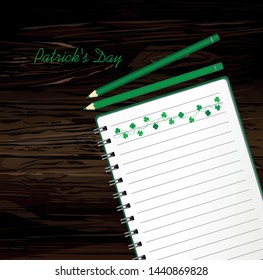 Notebook with template hand-drawn Green festive bunting with clover and pencil. Irish holiday - Happy St. Patrick's Day with a garland of three-leaf. Greeting card on holiday. Vector on wooden back.