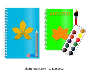 Bloc de notas para escribir o dibujar con una hoja de otoño en la cubierta, junto a un lápiz y pinturas y pinturas de borradores y acuarelas.