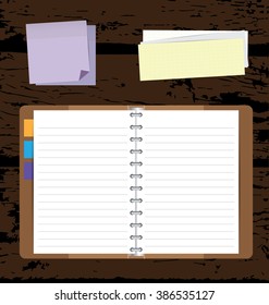 Cuadernos con post it y bloc de notas sobre fondo de madera.