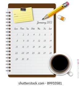 Notepad calendar 2012 January with coffee and pencil