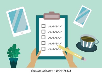 Notepad with a paper written CHECKLIST on green background