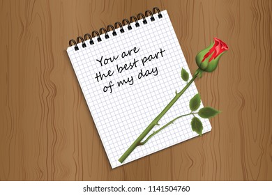 a notepad with a signature you are the best part of my life and a rose on a wooden background