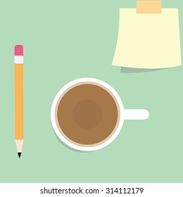 notepaper with pencil and a cup of coffee on green