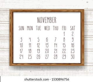 November year 2019 vector monthly calendar. Week starting from Sunday. Hand drawn text in a wooden frame over light brown rustic distressed wood background.