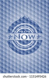 Now blue badge with geometric pattern.