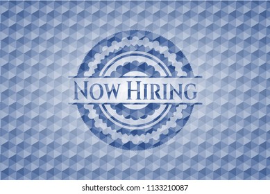 Now Hiring blue emblem with geometric pattern.