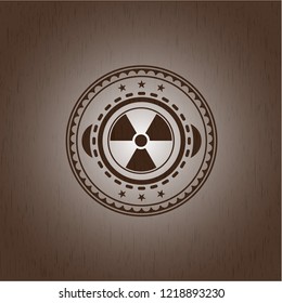 nuclear, radioactive icon inside badge with wooden background