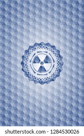 nuclear, radioactive icon inside blue badge with geometric background.