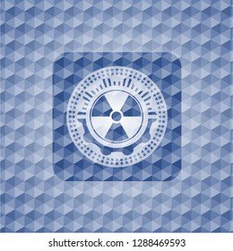 nuclear, radioactive icon inside blue emblem or badge with abstract geometric polygonal pattern background.