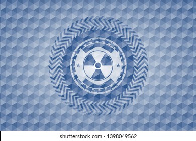nuclear, radioactive icon inside blue emblem or badge with abstract geometric polygonal pattern background.