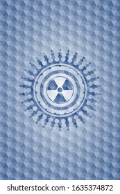 nuclear, radioactive icon inside blue badge with geometric pattern background.