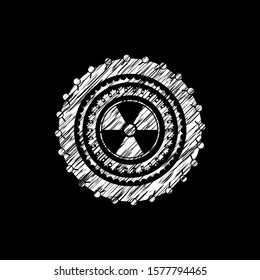nuclear, radioactive icon inside chalk emblem written on a blackboard