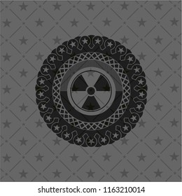 nuclear, radioactive icon inside dark emblem. Retro