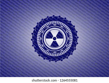 nuclear, radioactive icon inside emblem with jean background